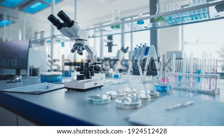 Modern Medical Research Laboratory with Microscope and Test Tubes with Biochemicals on the Desk. Scientific Lab Biotechnology Development Center of High-Tech Equipment, Technology.