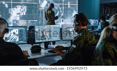 Military Surveillance Officer Working on a City Tracking Operation in a Central Office Hub for Cyber Control and Monitoring for Managing National Security, Technology and Army Communications. ストックフォト © 