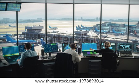 Diverse Air Traffic Control Team Working in a Modern Airport Tower. Office Room is Full of Desktop Computer Displays with Navigation Screens, Airplane Departure and Arrival Data for Controllers. Foto stock © 