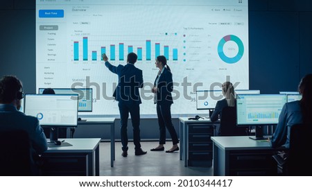 Similar – Image, Stock Photo Business colleagues discussing financial data working together in office. People entrepreneurs working with charts and tables on computer. Two people working together