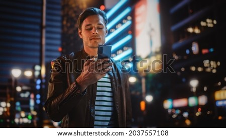 Similar – Image, Stock Photo Urban stylish young man standing by the wall using cellphone