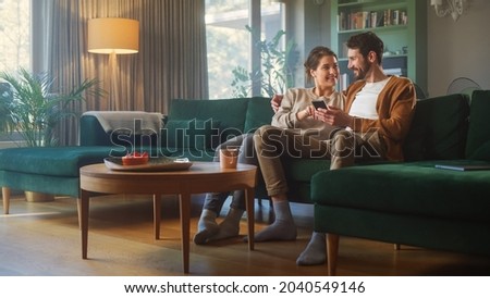 Similar – Image, Stock Photo Couple using smartphone together on bench