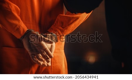 Cinematic Close Up Footage of a Handcuffed Convict at a Law and Justice Court Trial. Handcuffs on Accused Criminal in Orange Jail Jumpsuit. Law Offender Sentenced to Serve Jail Time. 商業照片 © 