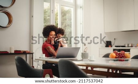 Similar – Foto Bild Mutter arbeitet am Laptop neben ihrem Sohn.