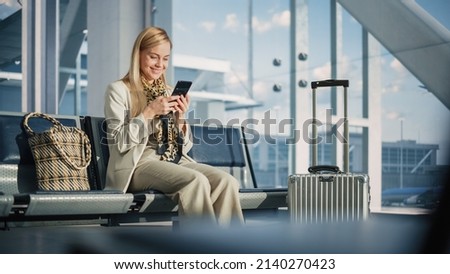 Airport Terminal: Woman Waits for Flight, Uses Smartphone, Browse Internet, Social Media, Online Shopping. Traveling Female Remote Work Online on Mobile Phone in a Boarding Lounge of Airline Hub Stock foto © 