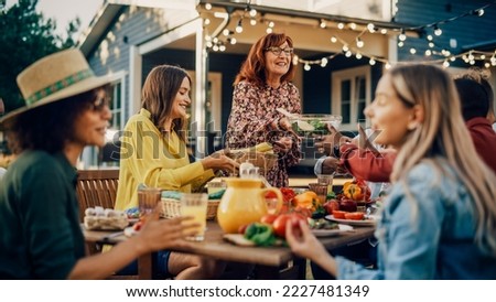 Family and Multiethnic Diverse Friends Gathering Together at a Garden Table. People Eating Grilled and Fresh Vegetables, Sharing Tasty Salads for a Big Family Celebration with Relatives. Foto stock © 