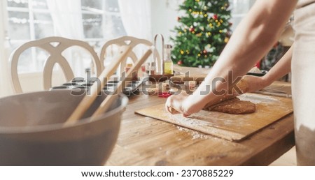 Similar – Image, Stock Photo Anonymous female cook rolling dough while using pasta machine