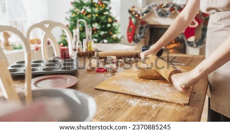 Similar – Image, Stock Photo Anonymous female cook rolling dough while using pasta machine