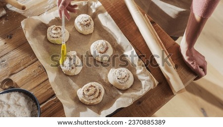 Similar – Image, Stock Photo Anonymous female cook rolling dough while using pasta machine