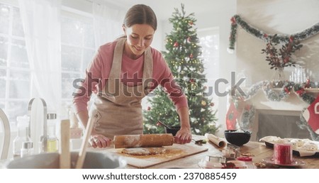 Similar – Image, Stock Photo Anonymous female cook rolling dough while using pasta machine