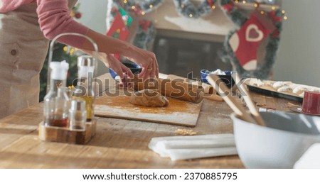 Similar – Image, Stock Photo Anonymous female cook rolling dough while using pasta machine