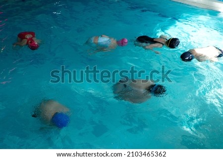 Children swimming training in a swimming pool. float exercise for buoyancy and proper breathing. deliverance of a person from the fear of water. Photo stock © 