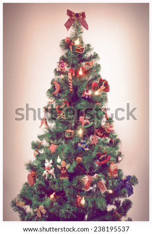 vintage filtered christmas-tree decorated with wooden toys and lights, old film