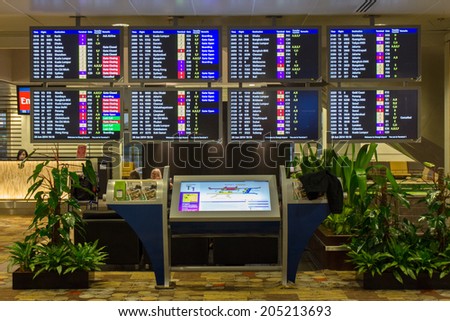 SINGAPORE - JUNE 20: Departure information monitors at Changi Airport, Singapore on June 20, 2014. Singapore airport is the main aviation hub in South East Asia.