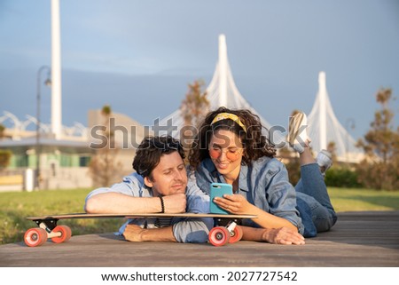 Similar – Image, Stock Photo Carefree male skater browsing cellphone in city