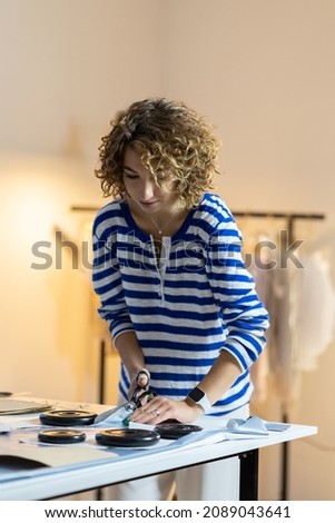 Similar – Image, Stock Photo Female tailor drawing cutout in workshop