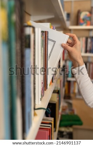 Similar – Image, Stock Photo Woman taking books out of cardboox. Unpacking parcel