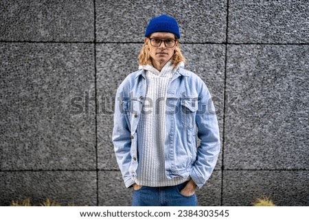 Image, Stock Photo Stylish androgynous man standing in darkness