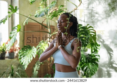 Similar – Image, Stock Photo Slim barefoot woman meditating in bound angle pose in contemporary workout room