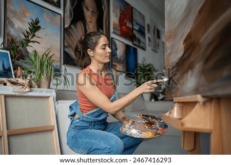 Similar – Image, Stock Photo Focused creative woman painting in studio