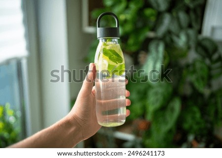 Similar – Image, Stock Photo Tasty infused water in bottle with drinking straw and ingredients: lime, strawberry and mint leaves at white background