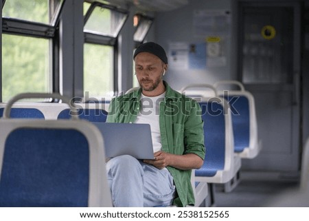 Similar – Image, Stock Photo Concentrated male passenger using laptop in train