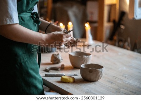 Similar – Image, Stock Photo Female ceramist making clay bowl in studio