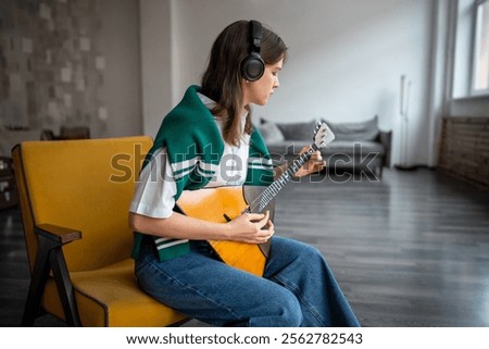 Similar – Image, Stock Photo Calm woman playing guitar in bedroom