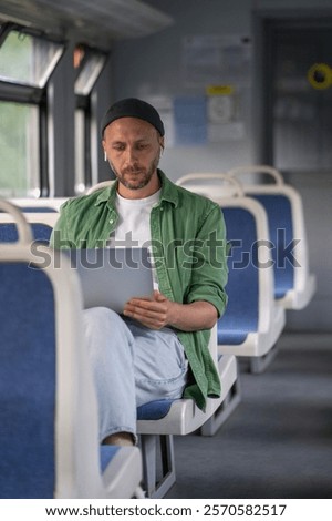 Similar – Image, Stock Photo Concentrated male passenger using laptop in train