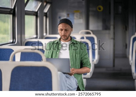 Similar – Image, Stock Photo Concentrated male passenger using laptop in train