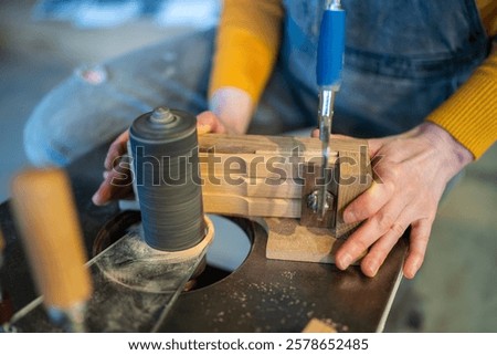 Image, Stock Photo Artisan polishing wooden detail using sandpaper in carpentry workshop