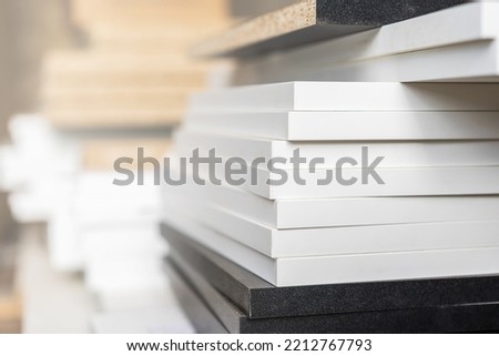 Edges of boards made of laminated chipboard, details of cabinet furniture in the assembly shop. Background with selective focus and copy space Foto d'archivio © 