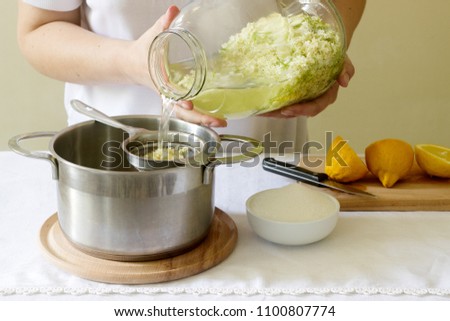 Similar – Image, Stock Photo Elder flower syrup ingredients: Elder branch, lemon and sugar in glass jar