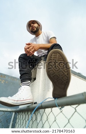 Similar – Image, Stock Photo Urban stylish young man standing by the wall using cellphone