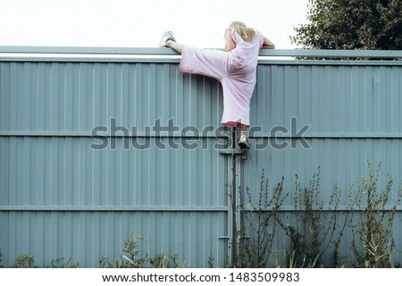 Similar – Image, Stock Photo Girls climb a fence in the spring in the garden.The concept of childhood, cheerfulness, carefree.