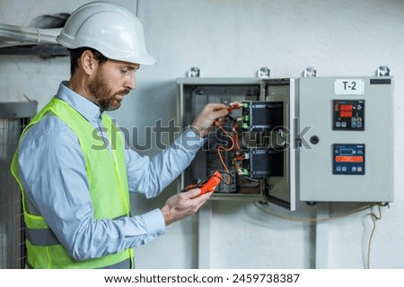 Similar – Image, Stock Photo Electrician working on the distribution panel of a house