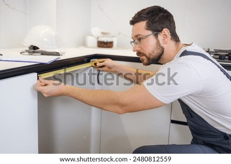 Similar – Image, Stock Photo Workman with measuring tape making surf board