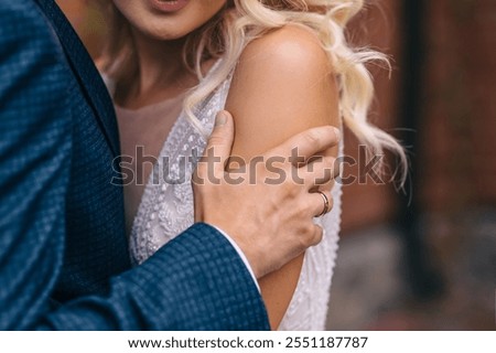 Similar – Image, Stock Photo Beautiful newlyweds hugging near the ancient door. Wedding portrait of a stylish groom and a young bride near old house in in a European town