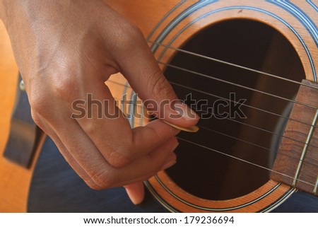 girl hand playing acoustic guitar, Close up of guitarist hand playing acoustic guitar