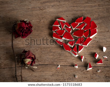 Broken heart with broken red glass and couple red rose dry on wood background for break my heart love, pain, sad. Accompanying sadness article. heart couple or poster. valentine concept. Stockfoto © 