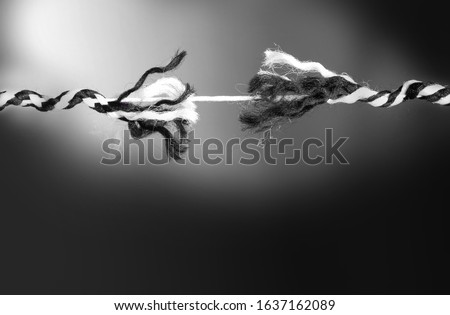 Close up of rope rope at breaking point on black background for broken heart concept. black and white image with copy space. 商業照片 © 