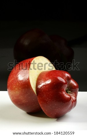 red apple cut in half on a black background