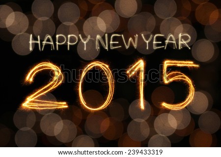 Happy New Year 2015 writing sparkle firework with dirty defocused gold light blur background