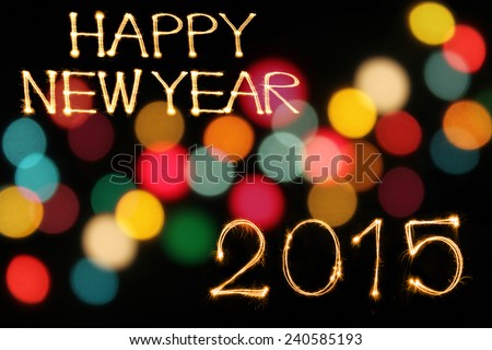 Happy New Year 2015 sparkle firework writing with unfocused dirty colorful light blur bokeh background