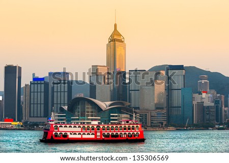 HONG KONG - MARCH 15: Victoria Harbor on March 15, 2013 in Hong Kong. Big Cruise Ship departed from Ocean Terminal and drove across Victoria Harbor at sunset.