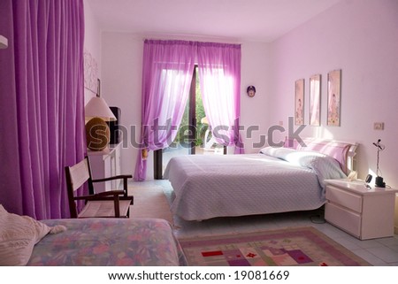 Interior of Beautiful bedroom with large window and television.