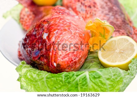 Fresh fish with with cabbage and lemon. Isolated on white.