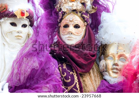 Three  masks in Venice, Italy. Shot with a flou filter to make a dreaming effect. High key image.