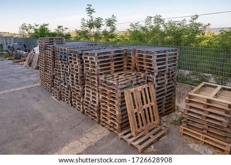 Shipping and transportation wood pallets in stacks waiting for bulk recycling in a freight warehouse shipment yard Stock fotó © 