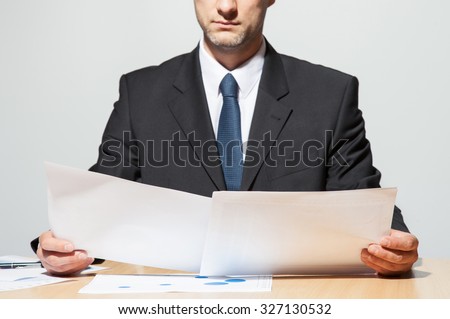 Businessman comparing two documents, neutral background 商業照片 © 